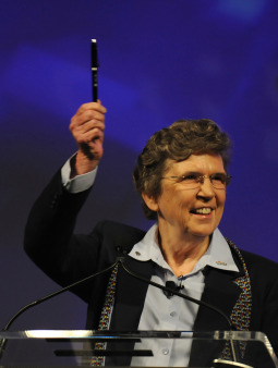 Sister Carol Keehan, a Daughter of Charity who is president and CEO of the Catholic Health Association, holds up a pen June 13 at the 2010 CHA convention in Denver. The ceremonial pen was one of 20 used by U.S. President Obama to sign the health care reform bill into law.