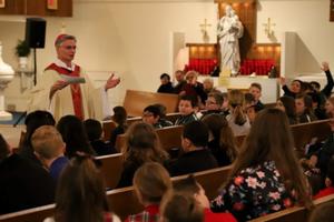 Bishop Thomas Daly shares the faith with students at recent Catholic Schools Week Mass.