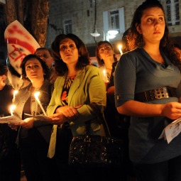 UNITED WE STAND? Palestinians attend a candlelight procession after a special memorial Mass Nov. 5 at Holy Family Church in Ramallah, West Bank, in solidarity for those killed in the Oct. 31 attack on Iraq's Syrian Catholic cathedral. Christians throughout the Middle East c alled for protection but said their faith keeps them strong.