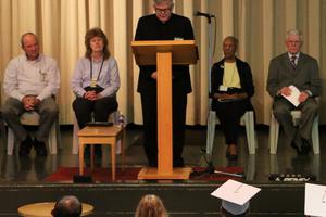 Msgr. Stuart Swetland, president of Donnelly College, speaks at Lansing Correctional Facility graduation exercises in May 2017. Donnelly has a branch at the prison in Lansing, Kansas, and reports that just 2% of Donnelly’s incarcerated students returned to prison.