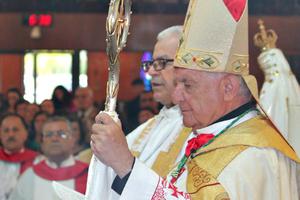 Above: Bishop Sarhad Yawsip Jammo at a diaconal ordination. Below in descending order: [first photo] Bishop Jammo with parishioners at St. Mary's Church in Campbell; [second photo] Bishop Gerald Dino confers the sacraments of initiation on an infant; [third photo] Bishop John Kudrick leads youth in chanting a traditional Marian hymn at the March for Life 2015; [fourth photo] a Byzantine Catholic priest offers the Divine Liturgy. 