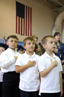‘I PLEDGE.’ Kindergarteners Carmelo Cancellieri, Victor Alongi and Liam Clifford recite the Pledge of Allegiance Nov. 10 during a Veterans Day concert at St. Lawrence School in Greece, N.Y.