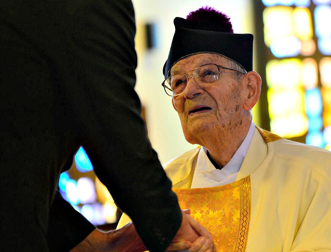 Above, Msgr. Vincent Topper, 103, receives congratulations from Father Andrew Stahmer, a priest of the Diocese of Harrisburg, Pa., prior to the Mass of thanksgiving on May 24 at St. Catherine Labouré Church in Harrisburg in celebration of the jubilarian’s 80th anniversary of ordination to the priesthood. Msgr. Topper, who turns 104 on July 28, is also shown on the occasion of his ordination. In addition, Sister Mary Anne Sweeney and some of the eighth-grade students from St. Catherine Labouré visit and pray the Rosary with Msg. Topper.