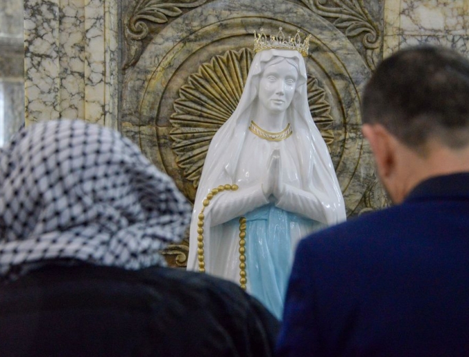 Iraqi Christians attend Christmas Eve Mass at the Syriac Catholic Church of the Immaculate Conception in the predominantly Iraqi Christian town of Qaraqosh, in Nineveh province some 30 kilometers (18.6 miles) from Mosul, on Dec. 24, 2019. The 2020 ‘World Watch List’ report found that 87% of Christians have left Iraq since 2003.