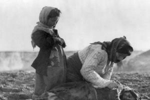 An Armenian woman kneels beside a dead child near the city of Aleppo, during the genocide carried out by the Ottoman Empire against Armenians that began in April 1915.