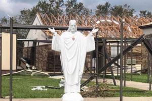 Statue of Jesus in front of damaged church property in the Diocese of Lake Charles.