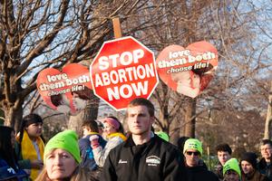 Marchers carry signs at the March for Life 2020.