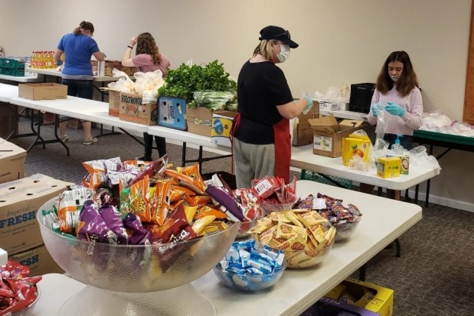 Volunteers and students prepare to open the Agape Food program at Kolbe Academy and Trinity Prep.