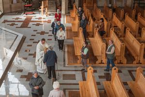 Parishioners social-distance while taking Communion amid the coronavirus pandemic in Lubin, Poland on May 21, 2020.
