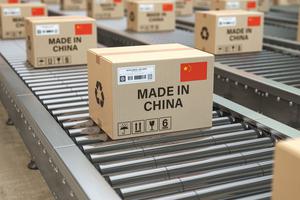 Cardboard boxes with text made in China and Chinese flag on the roller conveyor. U.S. government acted on Sept. 14, 2020 to withhold release of 5 categories of items from the Chinese province of Xinjiang and Anhui