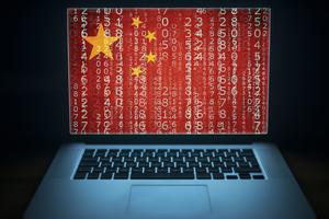 Laptop with binary computer code and china flag on the screen.