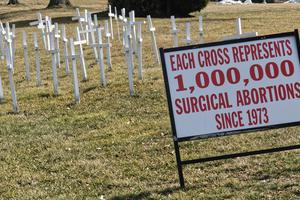 White crosses in front of a church in Lansdale, PA on March 14, 2019 with a sign that says "Each Cross Represents 1,000,000 Surgical Abortions Since 1973."