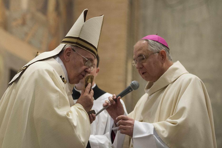 Pope Francis kisses a relic of Blessed Junipero Serra presented by Archbishop Jose H. Gomez of Los Angeles, California at the conclusion of Mass celebrated at the Pontifical North American College in Rome May 2, 2015. It was the first papal visit to the U.S. seminary since 1980. Saint Junipero Serra was an 18th century missionary who worked to defend the native people in America against the abuses of colonialism.