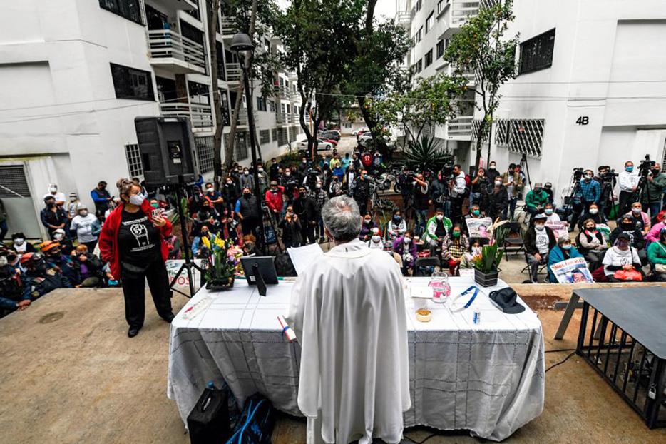 A priest offers Mass at the Tlalpan multifamily complex on the third anniversary of the earthquake that destroyed part of its buildings in Mexico City, on Sept. 19, 2020.