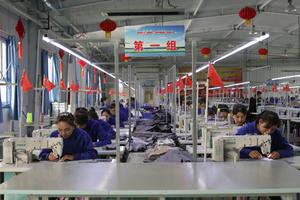 Uyghur women work in a cloth factory in Hotan county, Xinjiang province, China.