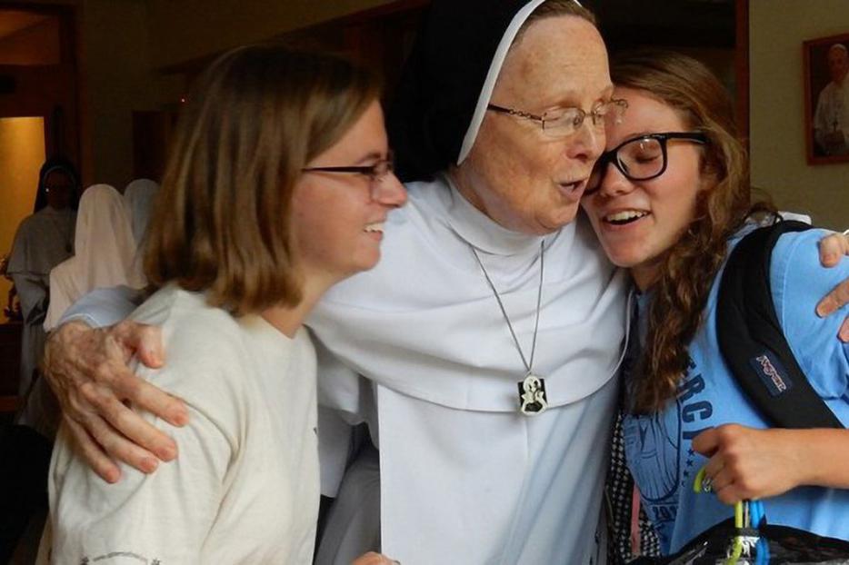 Dominican Sister Joseph Andrew Bogdanowicz hugs new postulants