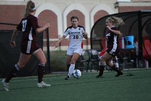 Emma Strecker, c, the captain of women’s soccer at Benedictine College, has her eye on the ball.