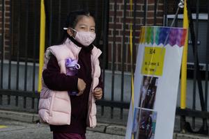 A student arrives for the the first day of school at St. Bartholomew Catholic Academy in Queens, New York, Sept. 21. Catholic schools in New York City and Boston, and elsewhere, have increased enrollment as many public schools delayed in-person learning.