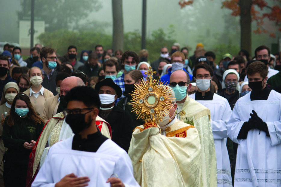 Bishop Jeffrey Montforton of Steubenville, Ohio, carrying a monstrance containing the Blessed
Sacrament, leads a procession from the Franciscan University campus through downtown Steubenville Oct. 3 as part of the nationwide ‘Unite the Nation’ events.