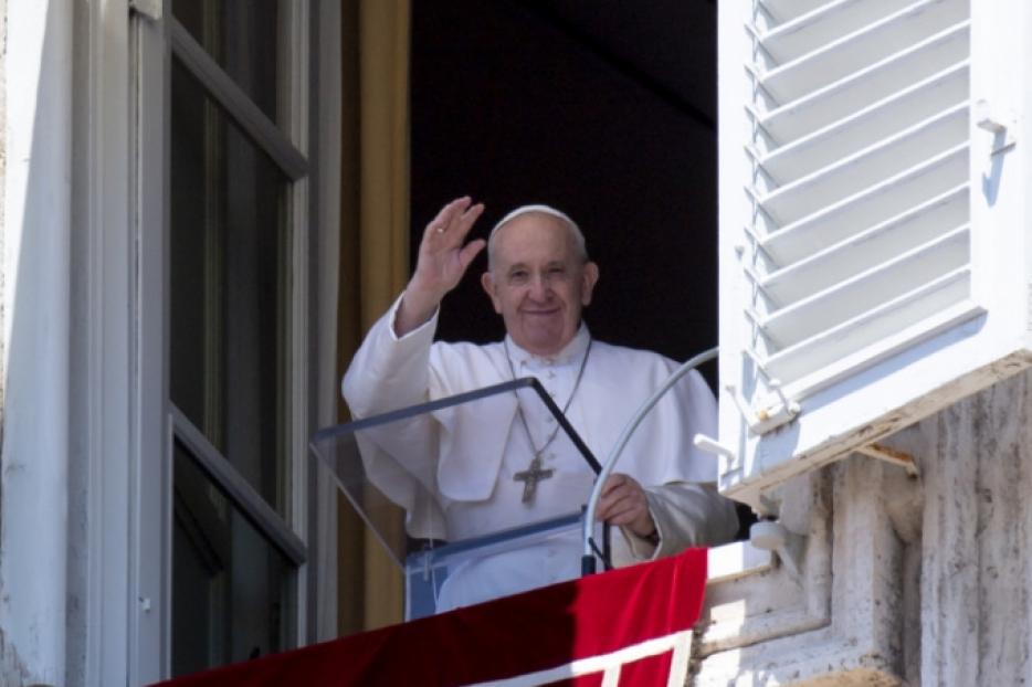 Pope Francis waves to pilgrims during his Angelus address.