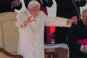 Pope Benedict XVI stands to show his thanks after a standing ovation from pilgrims at his last General Audience on February 27, 2013.