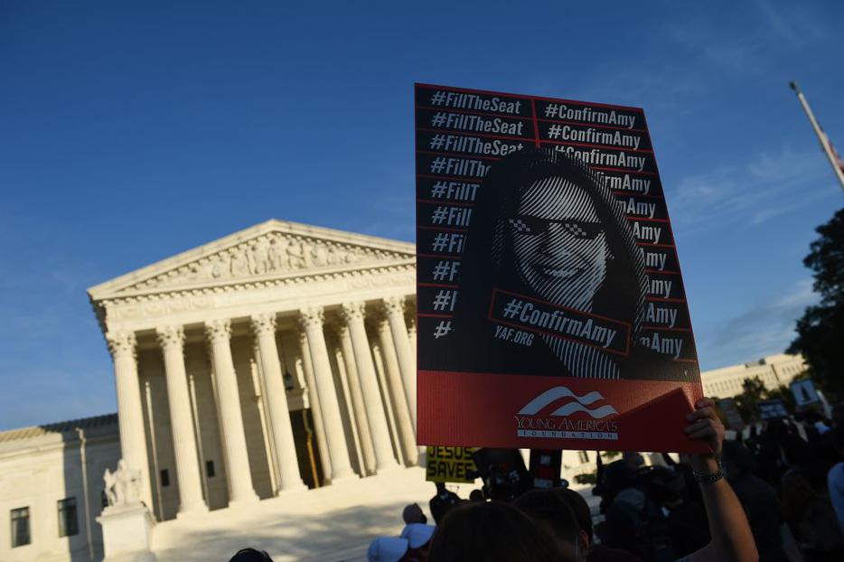 Supporters of Judge Amy Coney Barrett gather outside of the U.S. Supreme Court. The Senate will vote to confirm the Supreme Court nominee on Capitol Hill on Oct. 26.