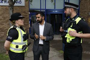 Humza Yousef, Scottish Justice Secretary, speaks with police officers, August 2018.