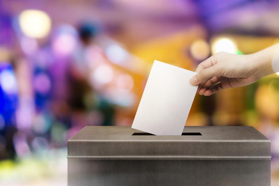 A ballot being placed in ballot box.