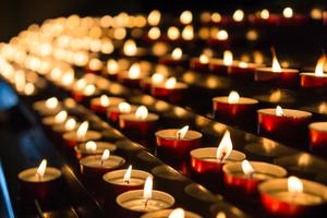 Candles burn inside a Catholic church.