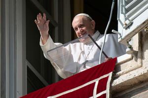 Pope Francis waves to pilgrims in St. Peter’s Square during the Angelus on Oct. 26.