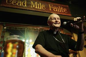 Cardinal Theodore E. McCarrick, Archbishop of Washington, speaks on the importance of serving God and the others to audiences during the "Theology on Tap" program at Ireland's Four Provinces Pub October 18, 2005 in Washington, DC.