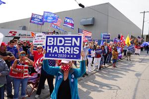 Voters hold signs during a rally outside of an aluminum foundry in Manitowoc, Wisconsin on September 21th, 2020.