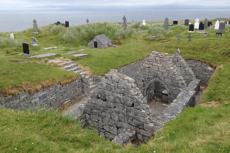 St. Caomhán’s grave behind the sunken church at Teampall Chaomháin