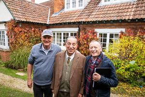 L to R: Executive Producer Ken Denison, actor Max McLean and Director Norman Stone (holding the script) smile in front of The Kilns, C.S. Lewis’ former home, where the trio were working on a new film.