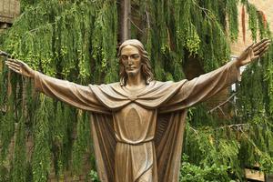 Bronze Statue of Jesus Christ in front of Church of Mary Queen of Haven in Brooklyn on July 13, 2013.