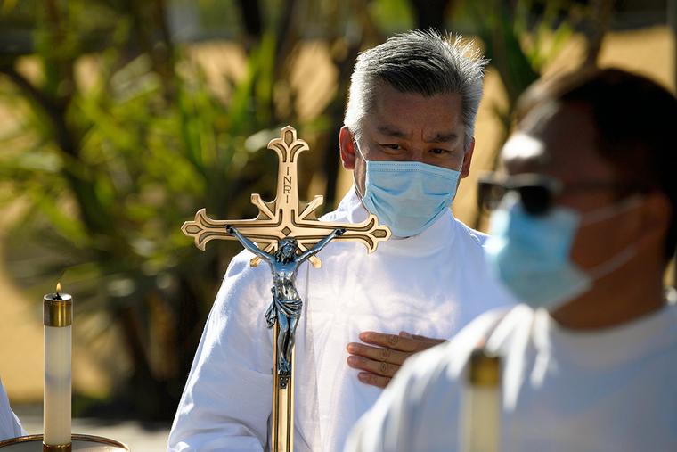 The processional cross is carried before the Archdiocese of Los Angeles’ 89th Our Lady of Guadalupe procession and Catholic Mass at the San Gabriel Mission in San Gabriel, California, Dec. 6, 2020.