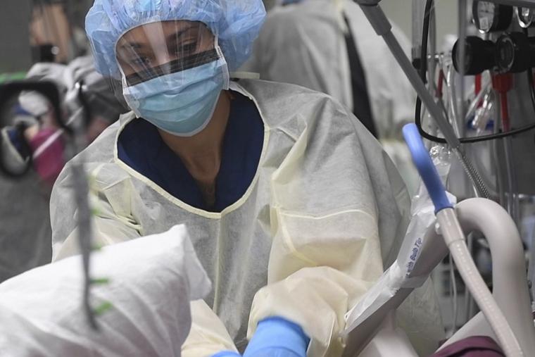Natasha McClinton, an operating room (OR) nurse, preparing a patient for a procedure in the intensive care unit (ICU) aboard the US hospital ship USNS Comfort (T-AH 20) in New York during the coronavirus pandemic.