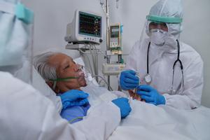 A doctor treats a COVID-19 patient amid the pandemic.