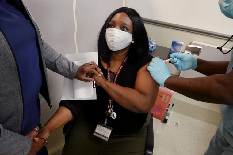 Latrice Davis, a nurse at Roseland Community Hospital, receives the COVID-19 vaccine on December 18, 2020 in Chicago, Illinois.