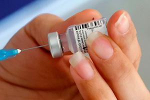 A healthcare worker prepares a dose of COVID-19 vaccine at Maccabi Health Services in the Israeli coastal city of Herzliya, north of Tel Aviv, on December 21, 2020. Israel has ordered 14 million doses of the vaccine -- covering seven million people, as two doses are required per person for optimal protection -- from Pfizer as well as US biotech firm Moderna.