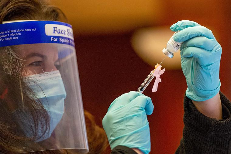 Nurse Laura Bailey draws the Moderna vaccine from the first batch of Moderna's vaccine at Hartford hospital in Hartford, Connecticut on December 21, 2020.