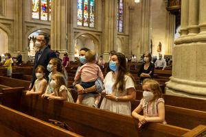 A family prays June 28, 2020, in New York during St. Patrick’s Cathedral’s first public Mass since March, when the pandemic stopped large gatherings, including public Mass.