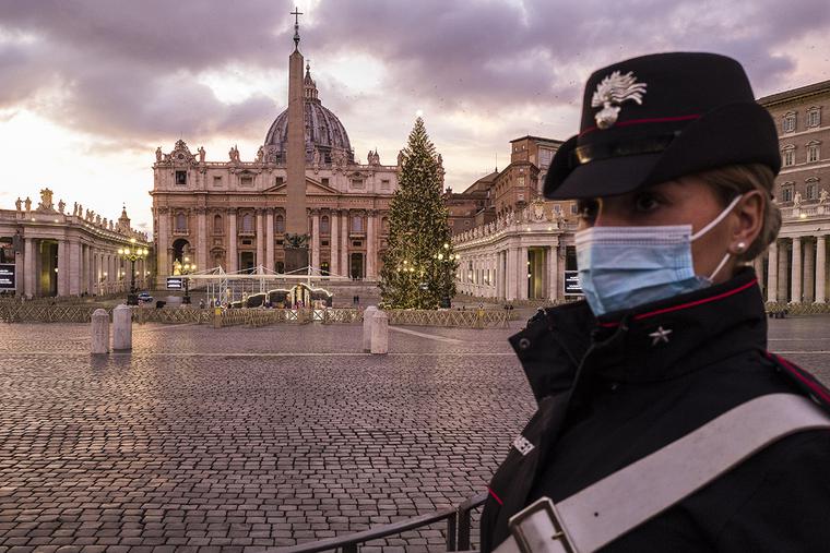 A carabiniere stands watch at an empty St. Peter's Square during the first evening of Italy’s nationwide lockdown on Christmas Eve, Dec. 24, 2020.