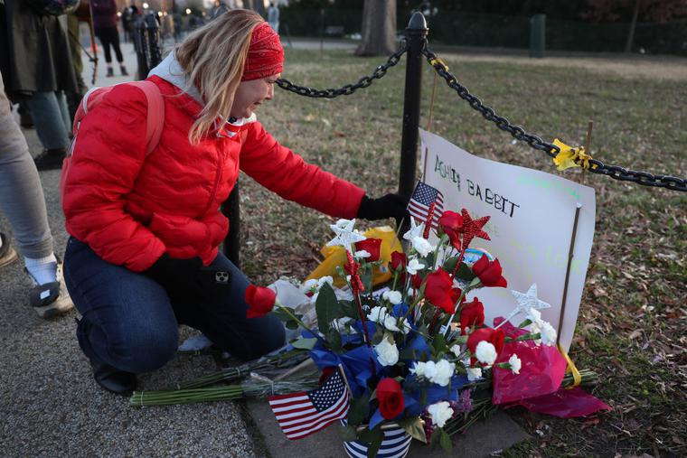 Melody Black, from Minnesota, becomes emotional as she visits a memorial setup near the U.S. Capitol Building for Ashli Babbitt who was killed in the building after a pro-Trump mob broke in on January 07, 2021 in Washington, DC.