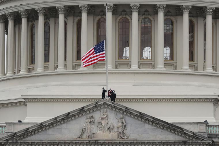 The American flag is lowered to half-staff atop the U.S. Capitol Building following the death of a U.S. Capitol Police Officer on January 08, 2021 in Washington, DC. The officer died after he was injured when a pro-Trump mob stormed and entered the Capitol Building on Wednesday.