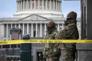 D.C. National Guard troops stand watch at the U.S. Capitol on Jan. 8 in Washington. Fencing was put up around the building the day before, following the storming of the Capitol by Trump supporters on Jan. 6.