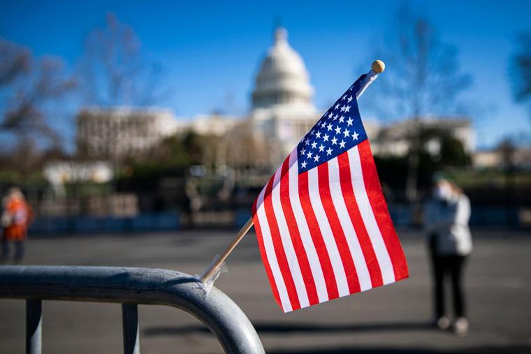 An American flag flies at a makeshift memorial for U.S. Capitol Police Officer Brian Sicknick, who was fatally injured when a pro-Trump mob stormed and entered the Capitol Building on Wednesday, near the West Front of the U.S. Capitol on January 9, 2021 in Washington, DC.