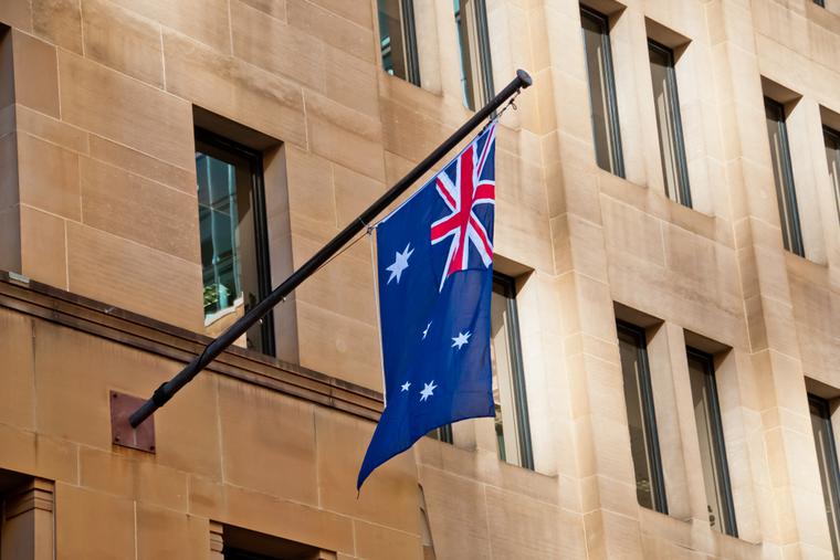 Australian flag hangs from side of building in Sydney.