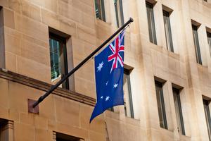 Australian flag hangs from side of building in Sydney.