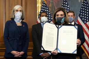 Speaker of the House Nancy Pelosi (D-CA) displays a signed article of impeachment against President Donald Trump at the U.S. Capitol on Wednesday in Washington, DC. The House of Representatives voted to impeach Trump a second time, after Vice President Mike Pence declined to use the 25th amendment to remove him from office after protestors breached the U.S. Capitol last week.